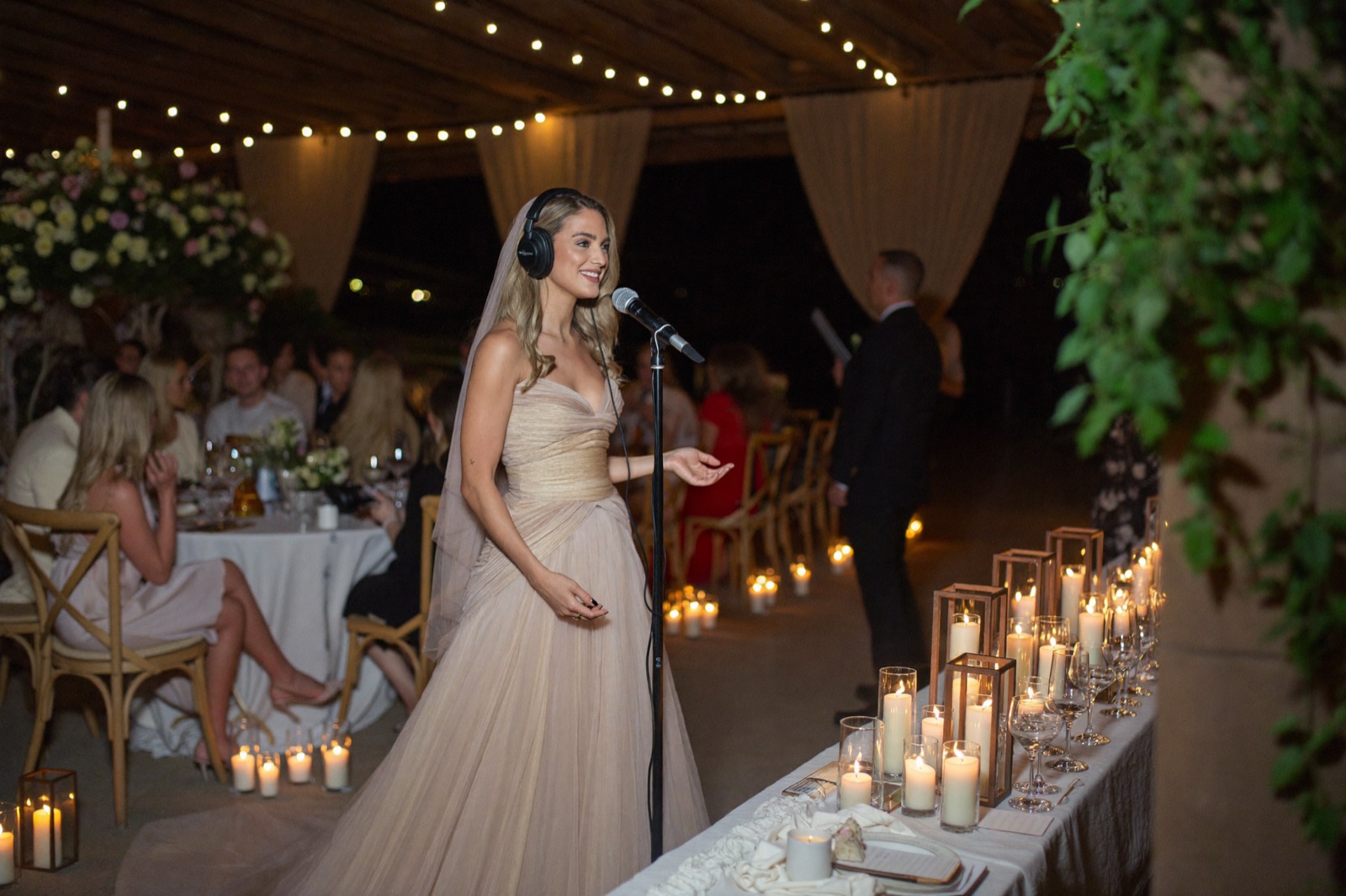 Candlelit hacienda-style podcast set with a maid of honor at the microphone